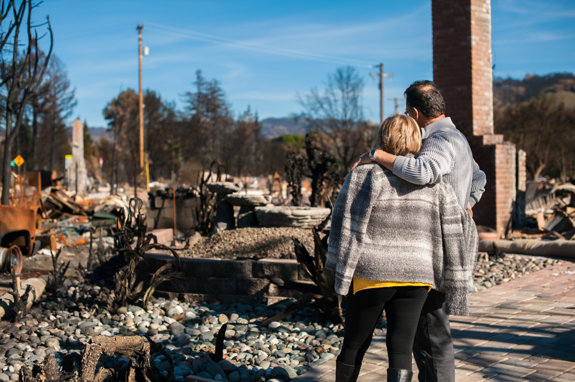 Homeowners checking ruins of their house and yard after fire