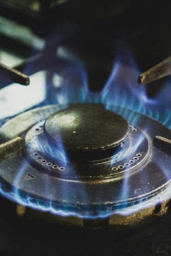 A gas stove element with blue flames