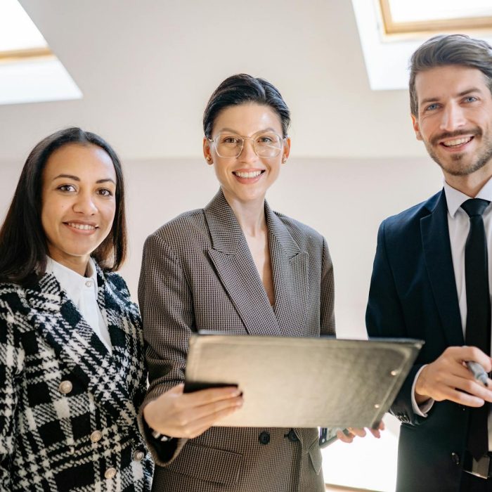 Modern business office team looking at the camera