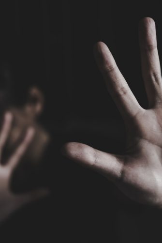 A person holding up hands in concept of ​​stopping an act of violence