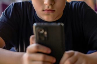 showing social media apps icons of Facebook, Instagram, WhatsApp, Twitter, Youtube, TikTok, Telegram, Gmail, Snapchat - on screen smartphone iPhone with AirPods closeup. Batumi, Georgia - August 9, 2022