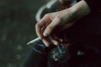 hand holding cigarette stock 