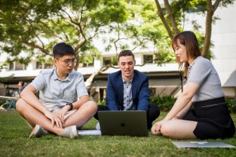Students studying in a group on the grass