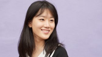 Happy student on coloured background