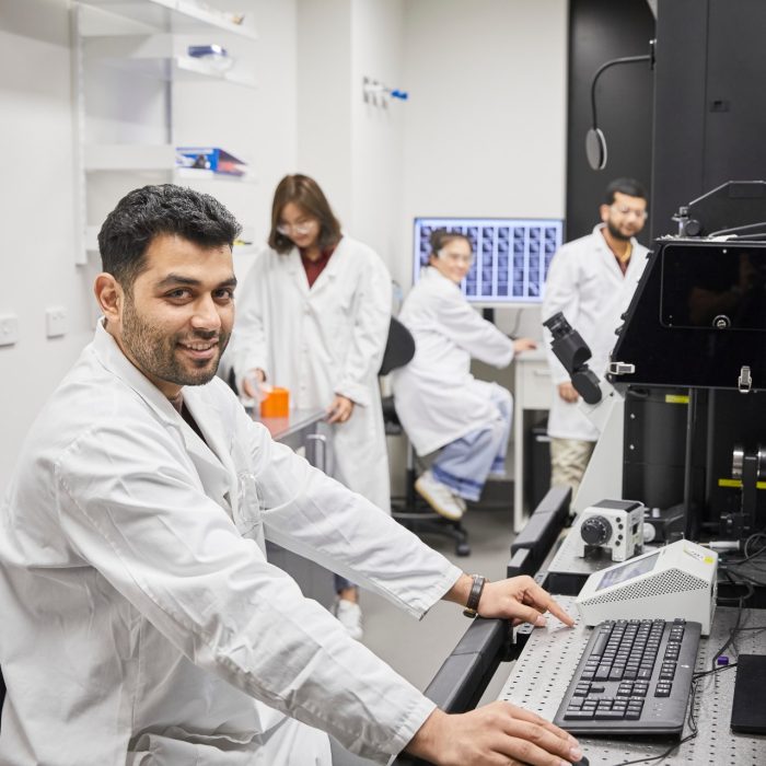 Researchers in laboratory using 3D printer