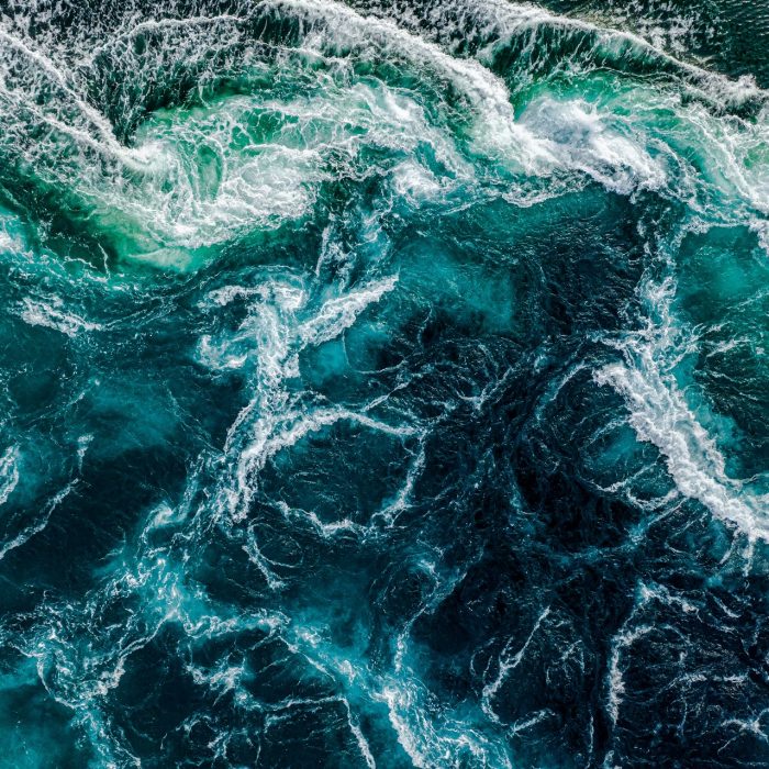 Abstract background. Waves of water of the river and the sea meet each other during high tide and low tide. Whirlpools of the maelstrom of Saltstraumen, Nordland, Norway