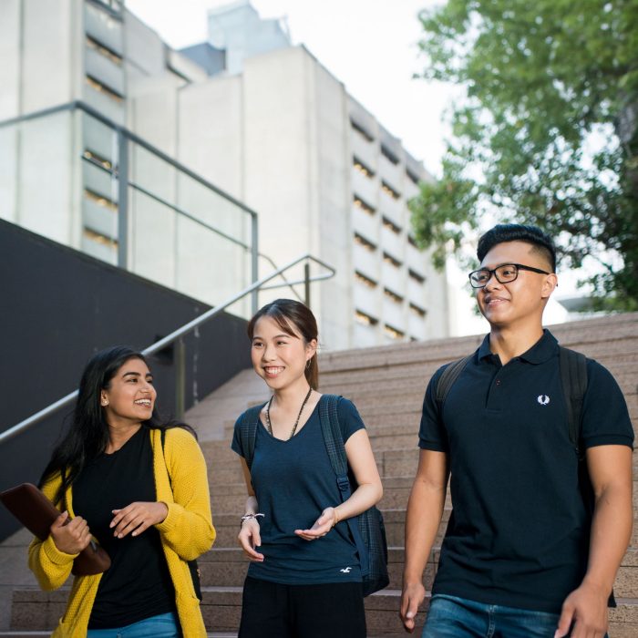 Photo of three students walking around campus