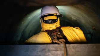 Photo of a worker taking photographs of internal pressure tanks in a confined space