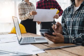 engineer working in office, engineer and architect use calculator for calculate drawing design construction, engineer discussion and estimate the cost of project.