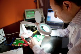 Photo of person working in electrical engineering lab