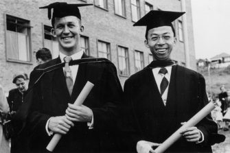 archive image of two graduates smiling