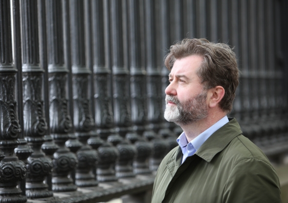A portrait picture of Paul Gladston with black fences on the background