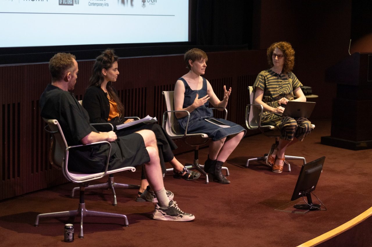 Four people on a stage in discussion