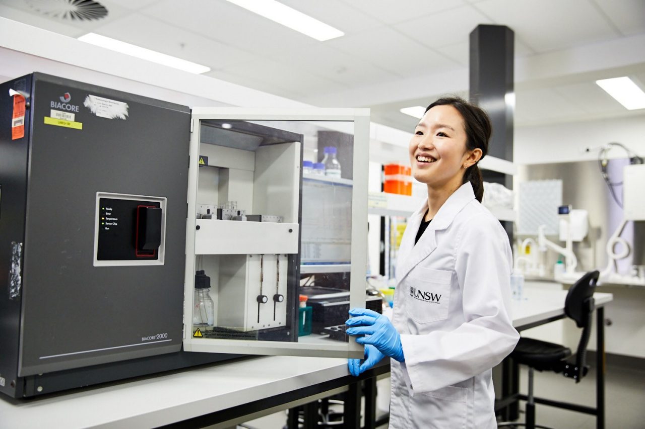 A laboratory technician working with engineering equipment