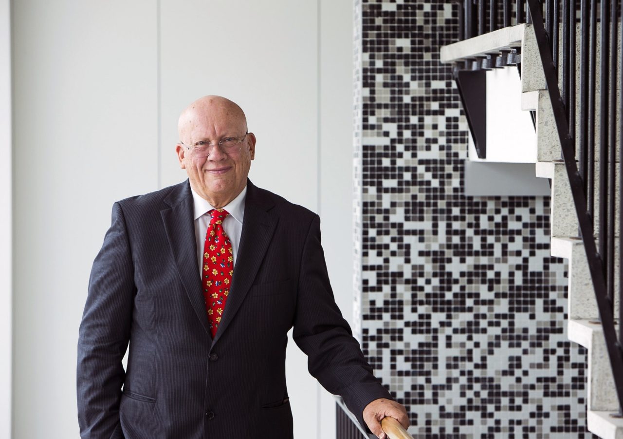 Peter Swan smiles while wearing a business suit