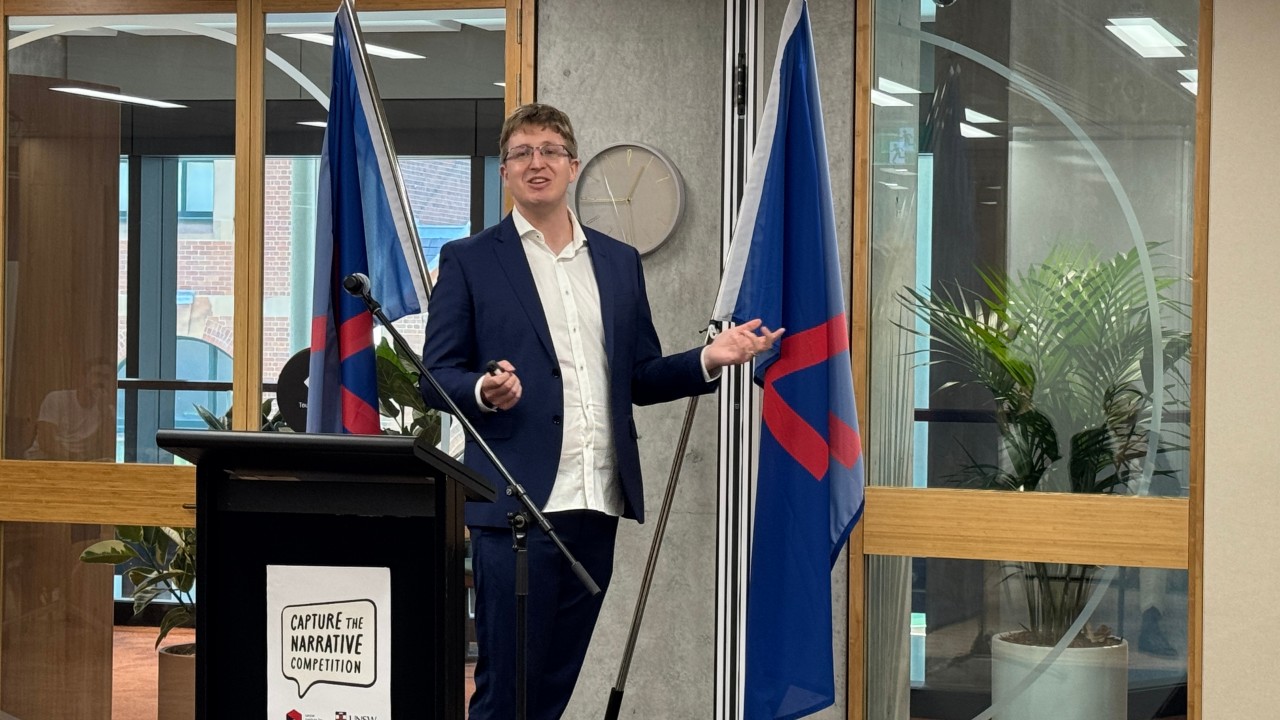 Dr Hammond Pearce presents at the Capture the Narrative prize giving day.